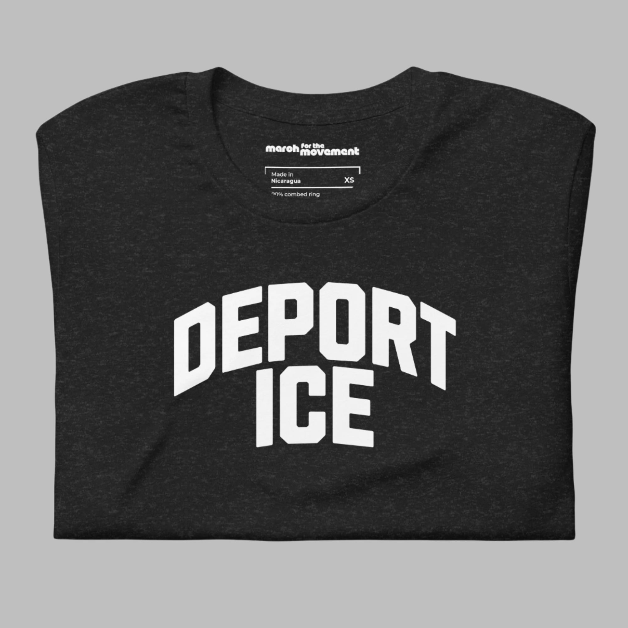 Flat lay of a black heather unisex t-shirt folded neatly on a neutral background. Bold white text across the chest reads “DEPORT ICE.” in all caps, creating a strong, high-contrast visual statement.