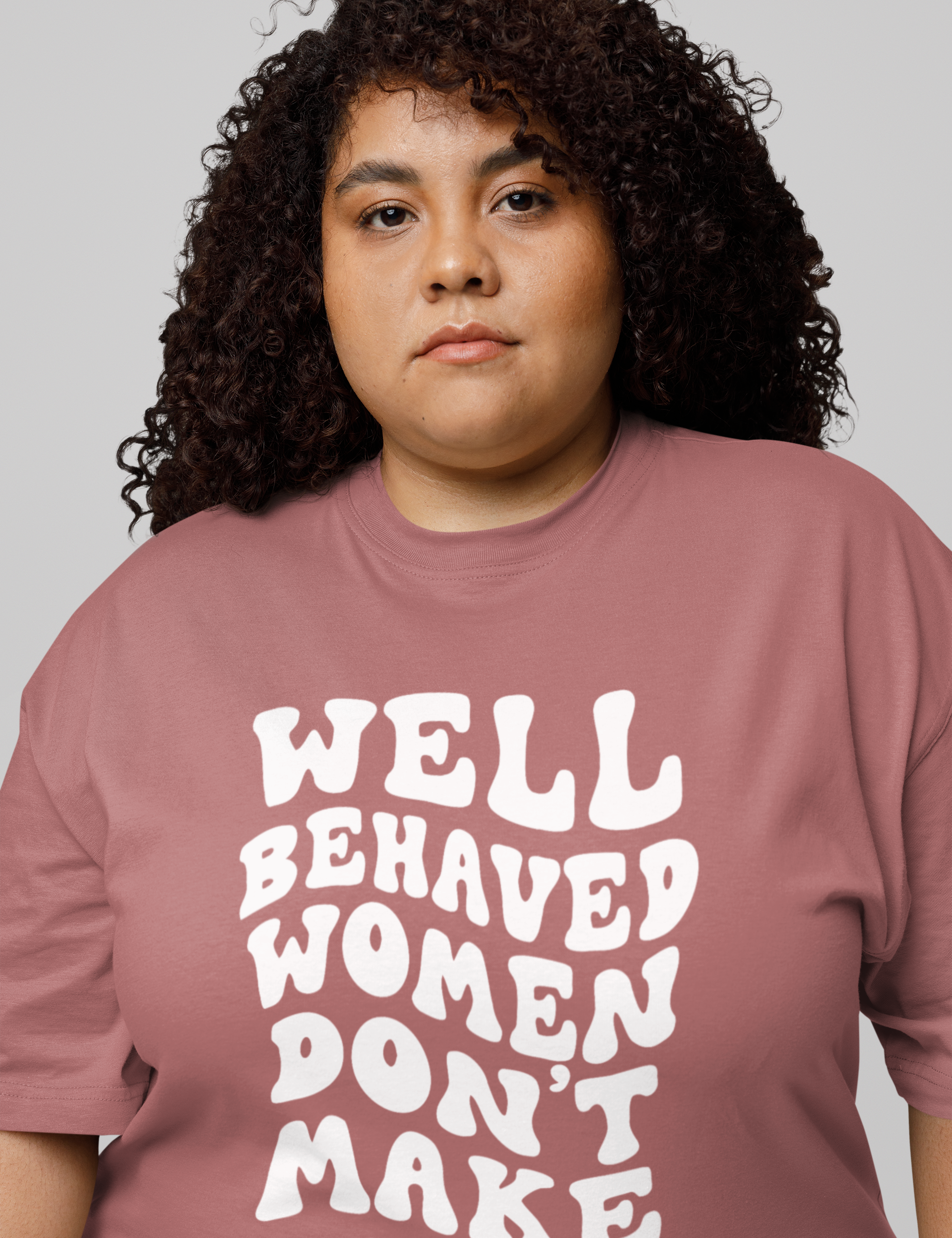 oversized-t-shirt-mockup-featuring-a-curly-haired-woman-posing-with-a-serious-look-in-a-studio-m38908.png