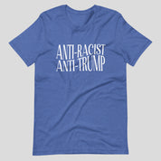 Flat lay of a blue heather t-shirt on a neutral background. The shirt features white serif text across the chest that reads: “Anti-Racist Anti-Trump.”