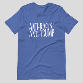 Flat lay of a blue heather t-shirt on a neutral background. The shirt features white serif text across the chest that reads: “Anti-Racist Anti-Trump.”