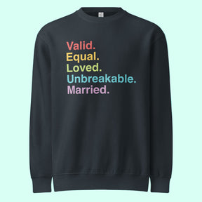 Navy sweatshirt with colorful text on a light blue background. The text reads "valid. equal. loved. unbreakable. married."