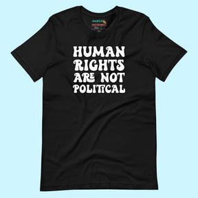 Flat lay of a black unisex t-shirt on a light blue background. The shirt features the bold white phrase “Human Rights Are Not Political” in all caps, centered on the front.