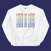 Flat lay of a white sweatshirt on a neutral background. The design features the phrase “Love is Love” repeated multiple times in multicolored vintage-style text across the chest, along with a March For The Movement logo.