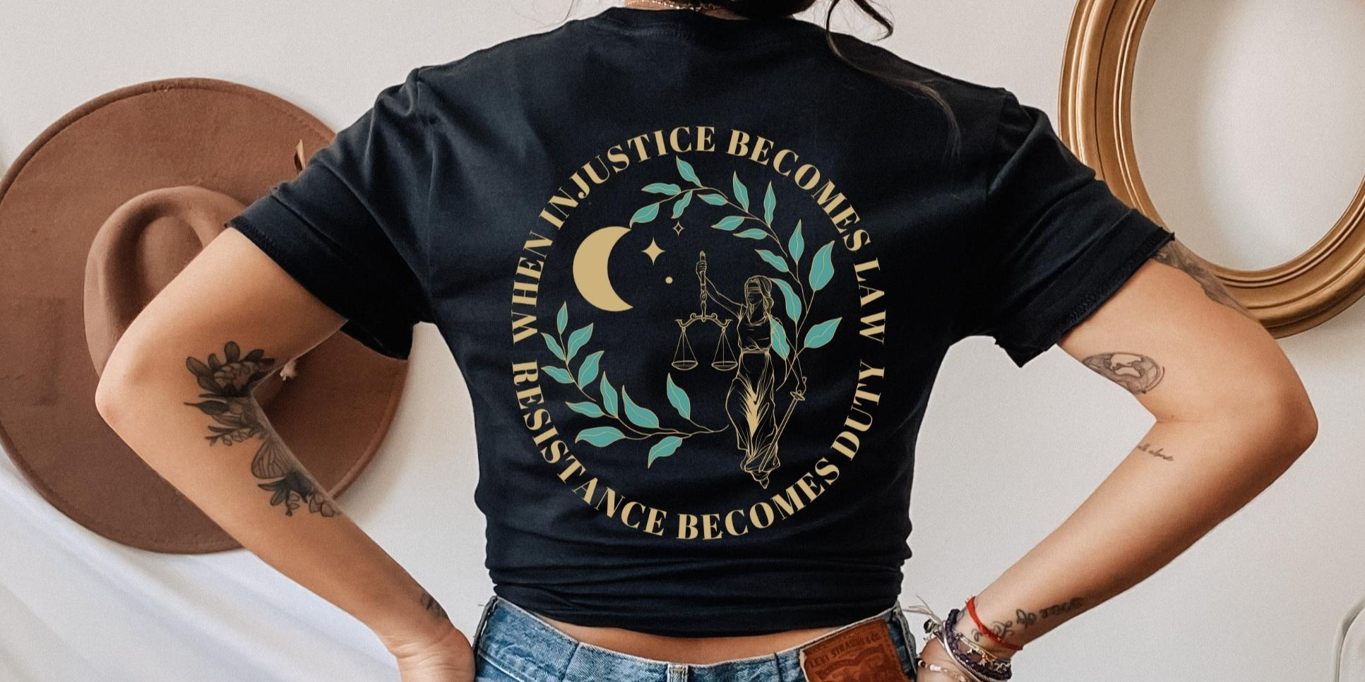 Model wearing a black t shirt that reads when injustice becomes law resistance becomes duty